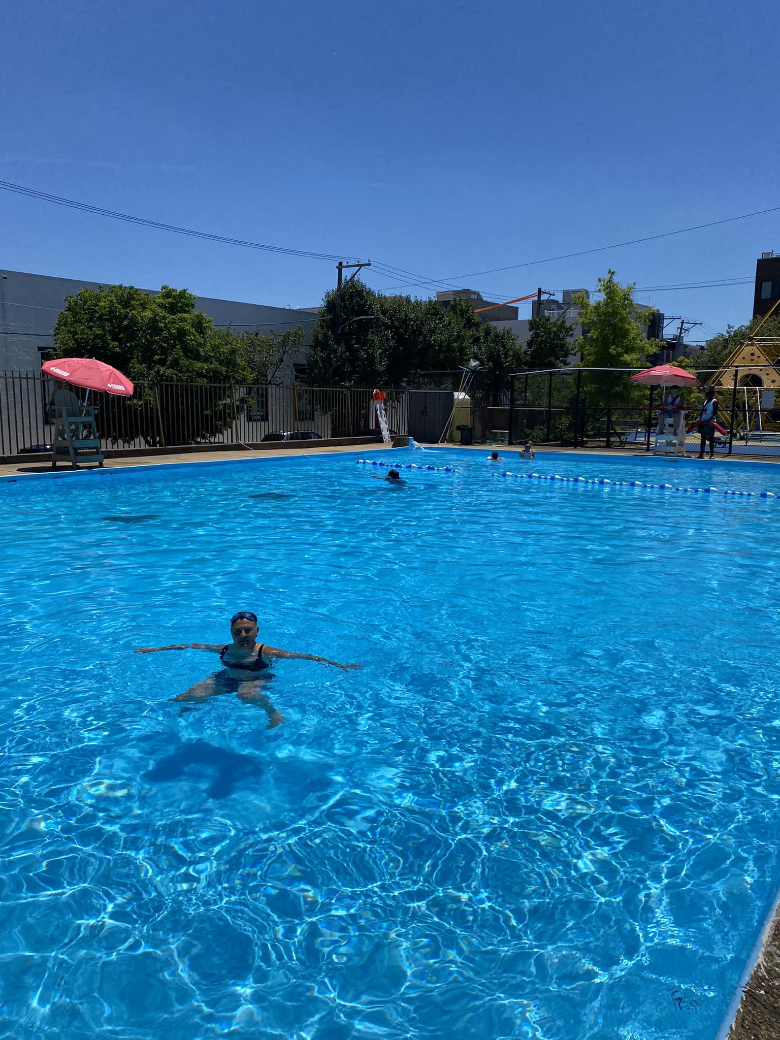 Photo of swimmer in nearly empty rectangular pool at Hancock Playground