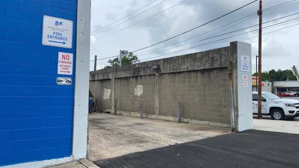 Pool entrnce sign points to loading dock